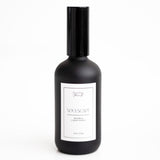 A black bottle of 'Soulscape' room and linen spray with a white label.