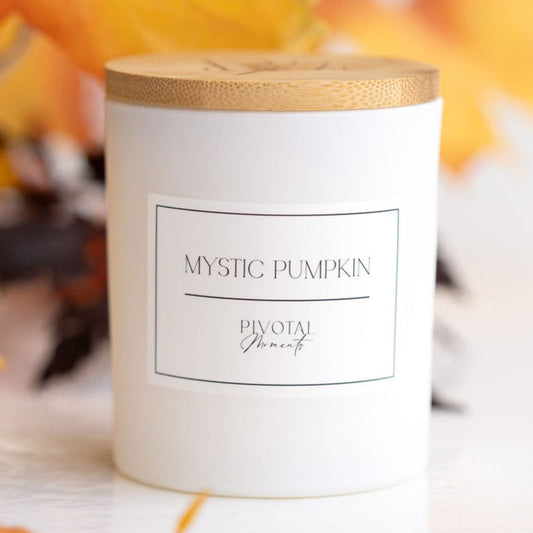 Mystic Pumpkin 12 oz signature candle by Pivotal Moments in a white glass vessel with bamboo lid