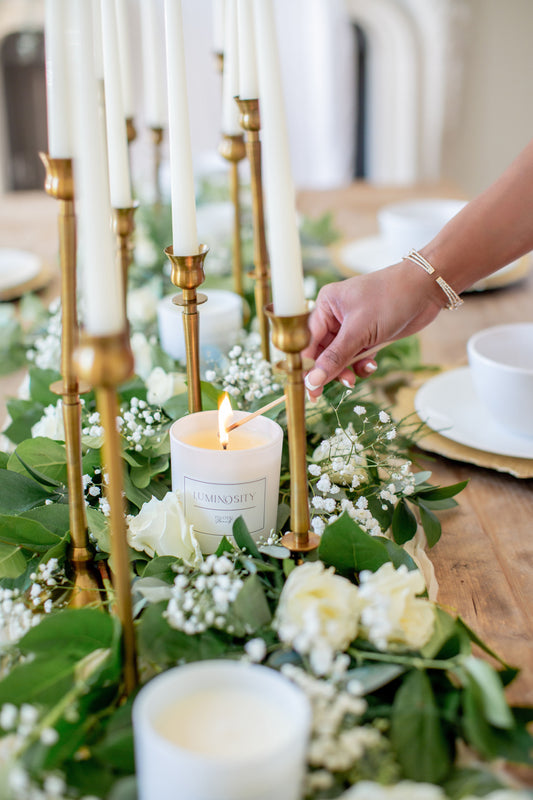 Pivotal Moment candles arranged amongst an elegant tablescape.
