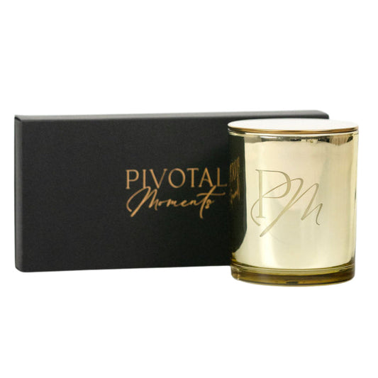 Holiday Glow gift set: gold PM monogram candle with Pivotal Moments black gift box