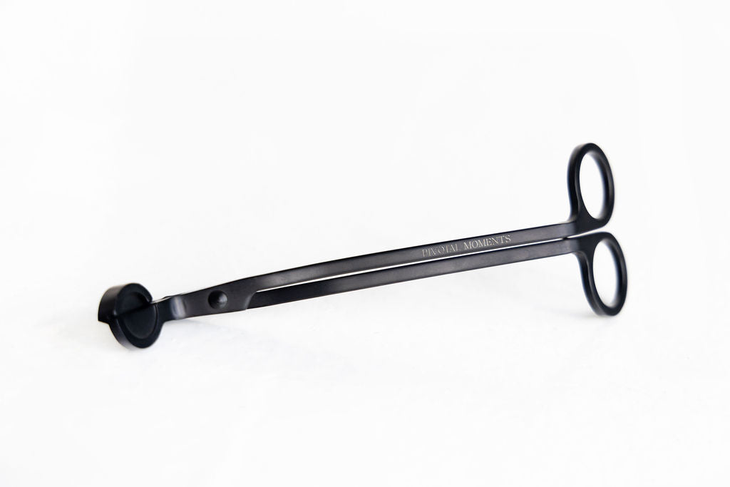 Black  candle wick trimmer with a handle on a white background