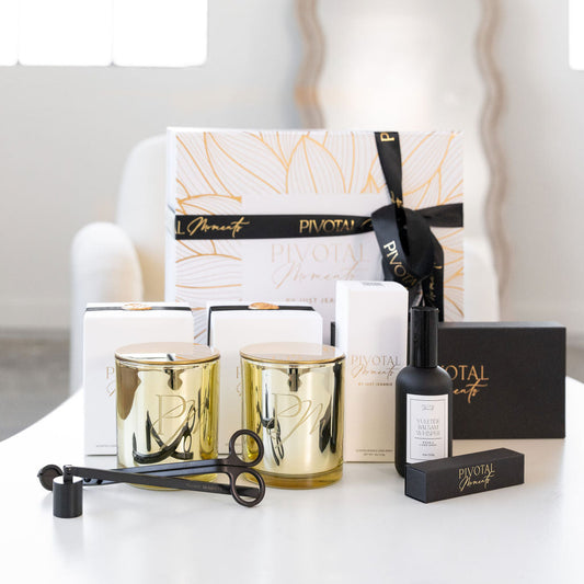 A gift set from Patchi, including various items like candles and bottles, presented in a decorative box with 'Festive' and 'Holiday' text, placed on a table with a white chair and a large window in the background.
