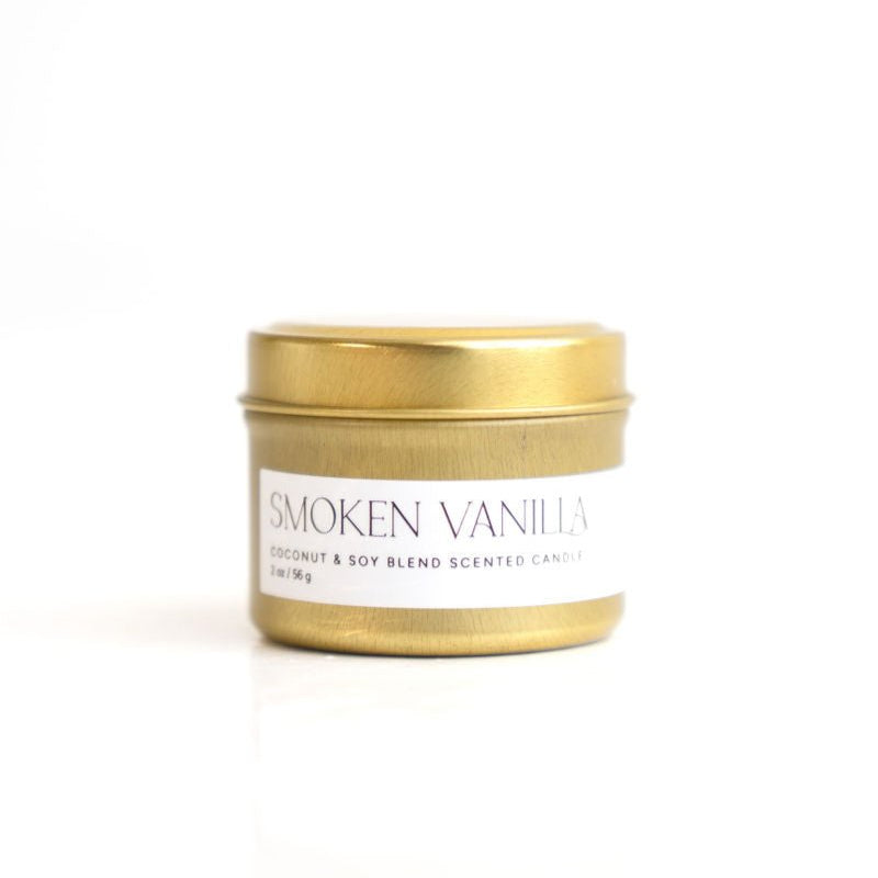 A white cylindrical candle with a wooden lid labeled 'SMOKEN VANILLA'.