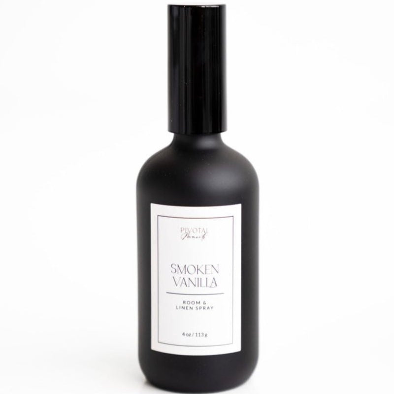 A black bottle of 'Smoked Vanilla' room and linen spray with a white label, containing 4 oz (120 ml).