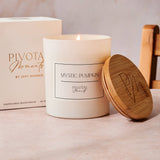 Mystic Pumpkin candle with wooden lid and packaging on a neutral background