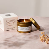 Gold candle with 'Mystic Pumpkin' label and packaging on a neutral background