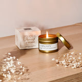 Candle with a box labeled 'Pivotal Elements' on a wooden surface with decorative elements.