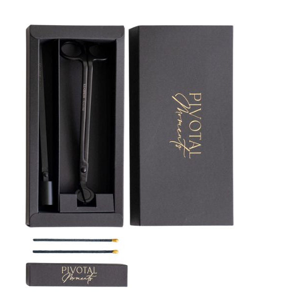 Black candle care with 'Pivotal Moments' branding in a box on a white background