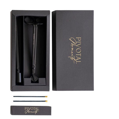 Black candle care with 'Pivotal Moments' branding in a box on a white background